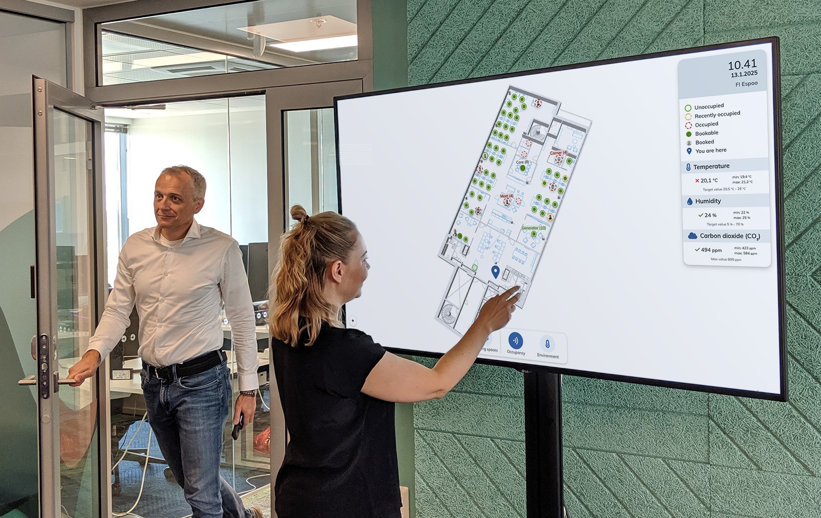 A woman using the EG Worksense on interactive kiosk display